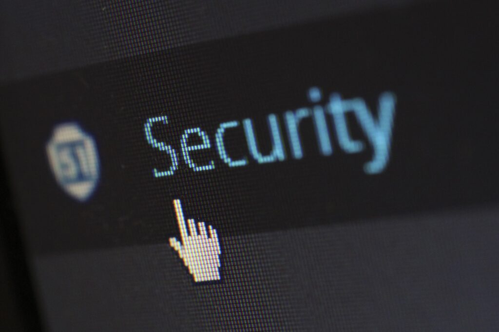 a hand icon hovering at the word security on a computer screen